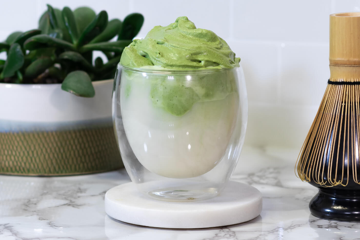 Premium Photo  Iced green tea matcha dalgona in two glasses with a straw  and a bowl of matcha powder for cooking on a wooden tray white background  space for text