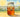 Whimsical hand-drawn illustration of a smiling sun shining on a mason jar filled with tea bags and water, sitting on a wooden surface outdoors. Text reads ‘How to Make Sun Tea’ and ‘A Simple Summer Brewing Method.
