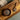 Wooden bowl and spoon with dried devil's claw on a wooden tray