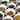 Assortment of loose-leaf teas displayed in small white bowls, featuring a variety of colorful dried herbs and tea blends on a dark surface