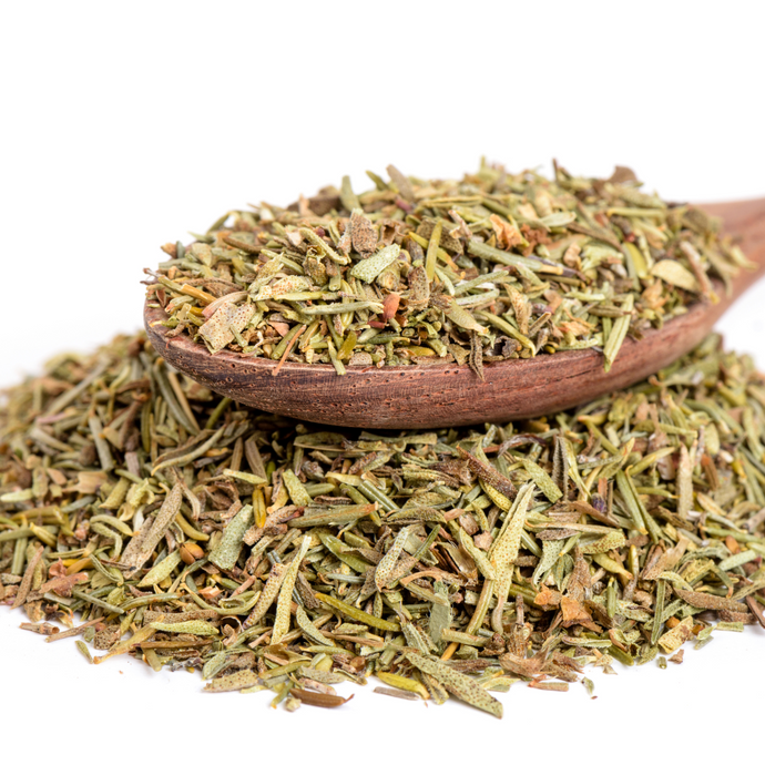 Wooden spoon filled with dried thyme herbs on a white background
