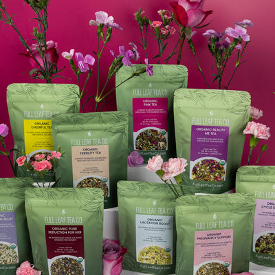 Collection of Full Leaf Tea Company tea packages with flowers against a pink background.