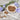 Dried chicory on a spoon and plate with chicory flowers on a wooden surface