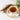Teacup with floral design filled with tea, cinnamon stick, and herbs on a light background
