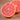 Close-up of a halved grapefruit on a wooden surface