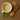 White cup of tea with dried herbs on a wooden surface
