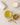 Mug of green tea with a bowl of gsenna leaf and a candle on a light surface