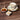 Teacup with floral design on a wooden table, accompanied by honey and sugar.
