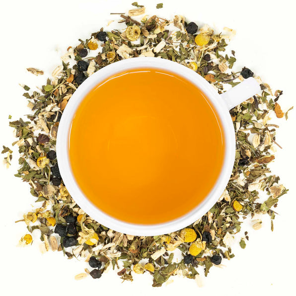A cup of Organic Bladder Health Tea with visible herbs surrounding it, such as ashwagandha, saw palmetto, schisandra berries, peppermint, marshmallow root, and chamomile.