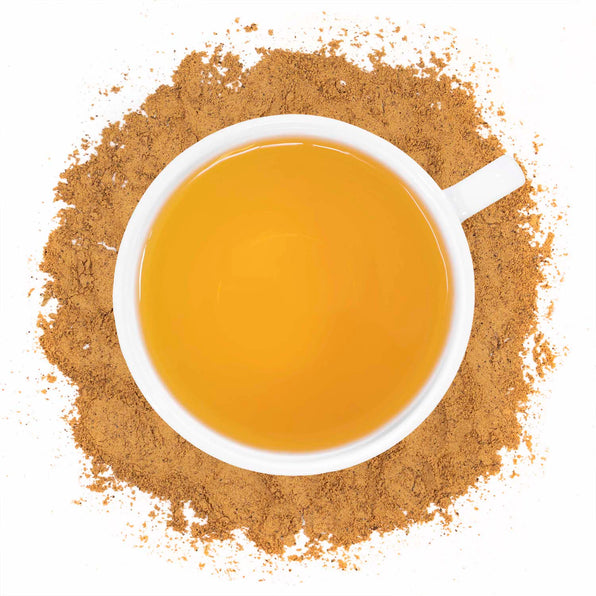 A cup of Organic Guarana Powder tea with a pile of guarana powder surrounding it.