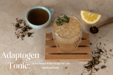 tea mocktail in a glass with the ingredients behind it. 