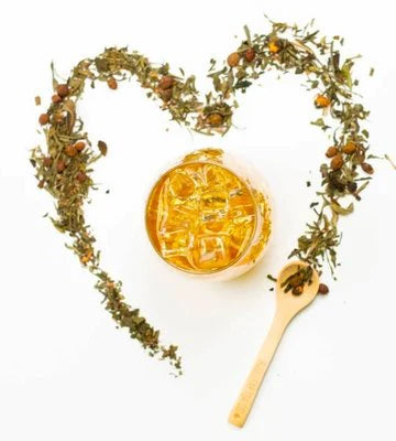 Tea filled, ingredients surrounding it in the shape of a heart