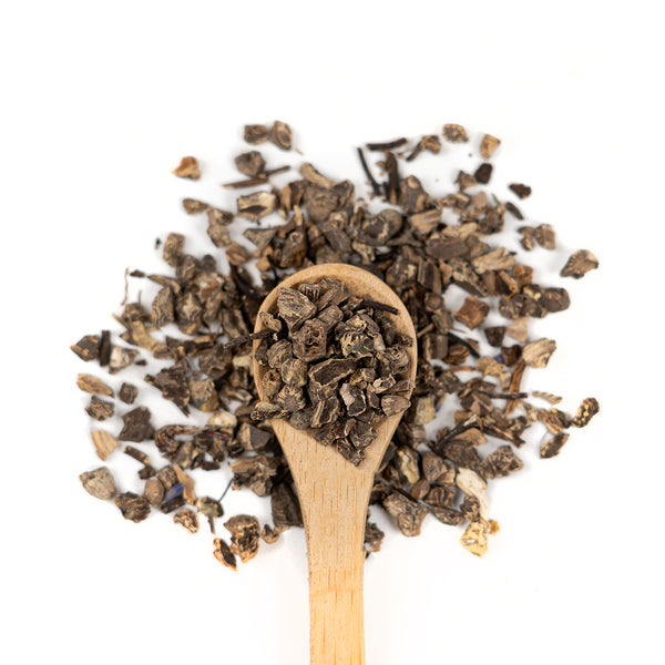Wooden spoon of Organic Black Cohosh on a white background.