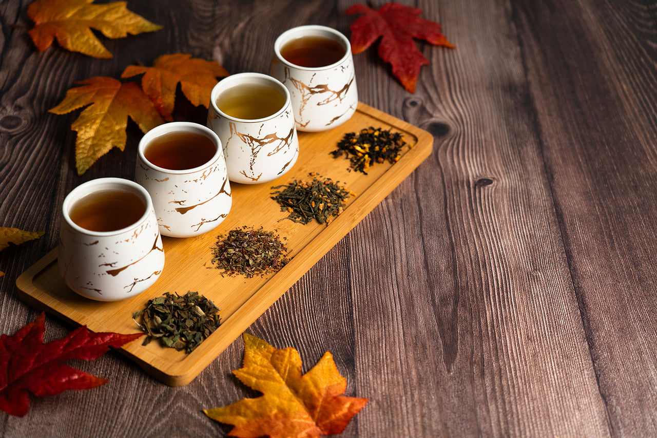 white marble tea set and loose leaf tea on platter