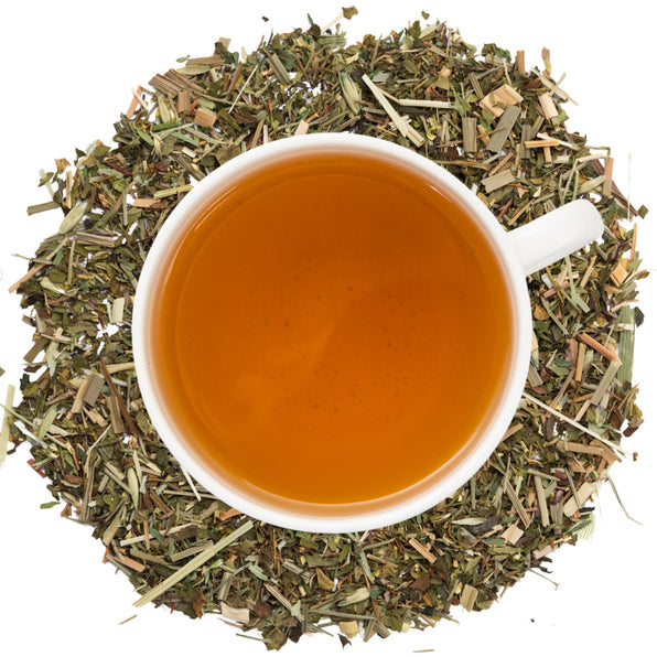 White cup of tea surrounded by dry bone health herbs on a white background