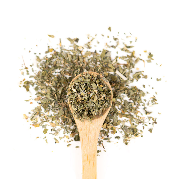 Wooden spoon of Organic Catnip on a white background.