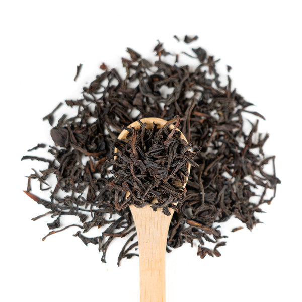 Wooden spoon of Organic Ceylon on a white background.