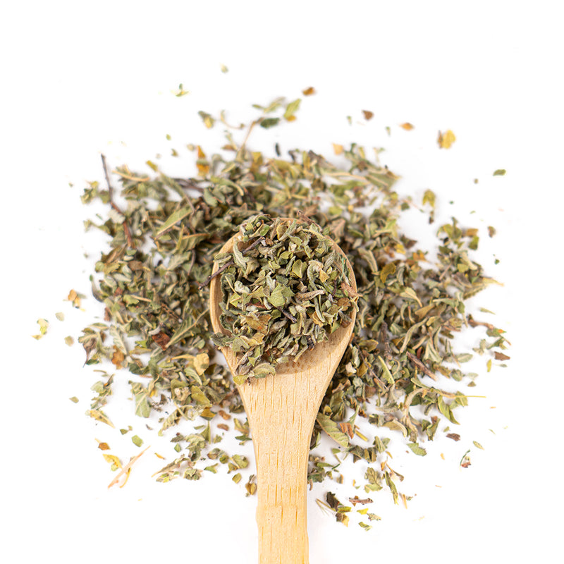 Wooden spoon of Organic Damiana Leaf on a white background.