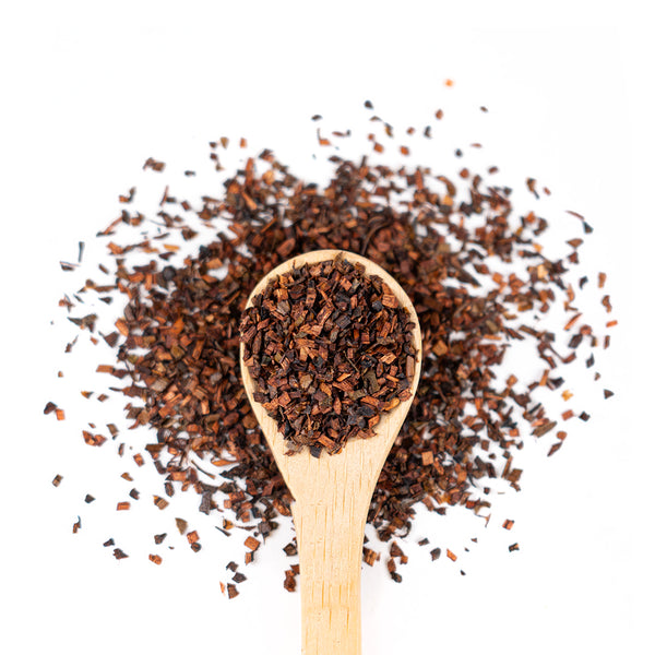Wooden spoon of Organic Honeybush on a white background.