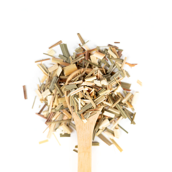 Wooden spoon of Organic Lemongrass on a white background.