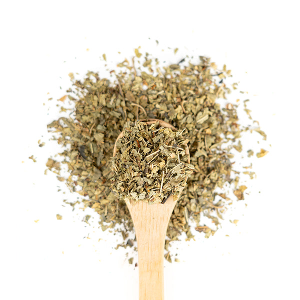 Wooden spoon of Organic Lemon Verbana on a white background.