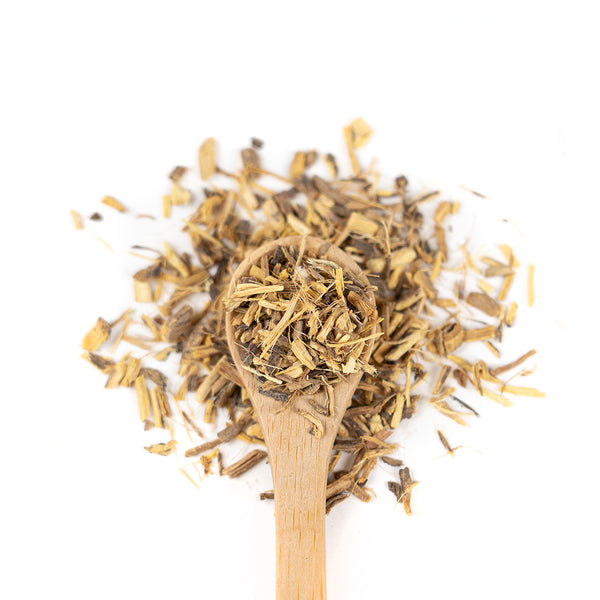 Wooden spoon of Organic Licorice Root on a white background.