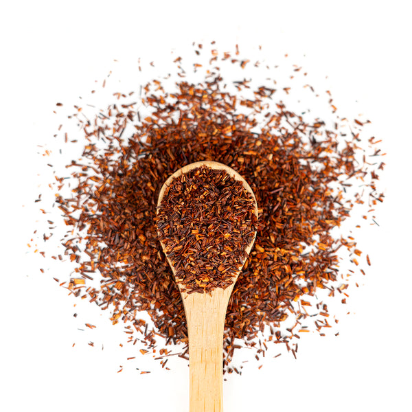 Wooden spoon of Organic Rooibos on a white background.