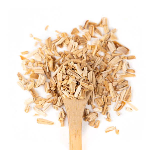 Wooden spoon of Organic Shatavari on a white background.