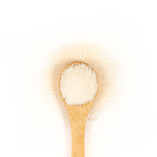 Wooden spoon of sugar on a white background.