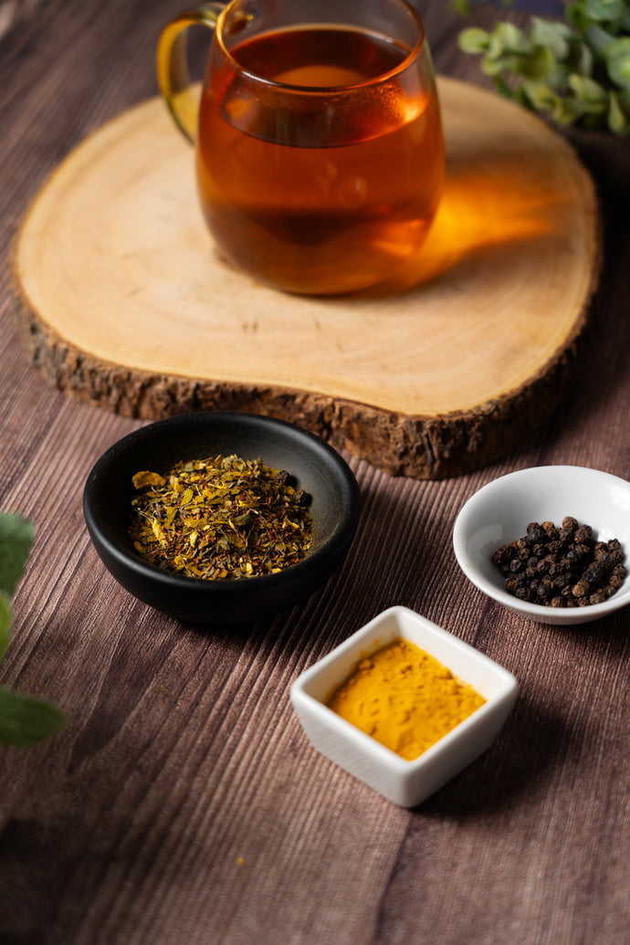 Tea cup with vertigo relief tea leaves and ingredients on a wooden surface