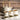 Elegant ceramic teapot with matching cups filled with tea, surrounded by bowls of loose leaf green tea on a marble surface.
