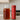 Red container with Full Leaf Tea Co branded on it and glass pitcher with tea on a kitchen counter